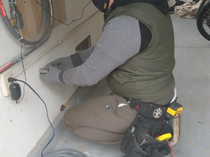 Electrician performing outlet wiring in a Batesville garage
